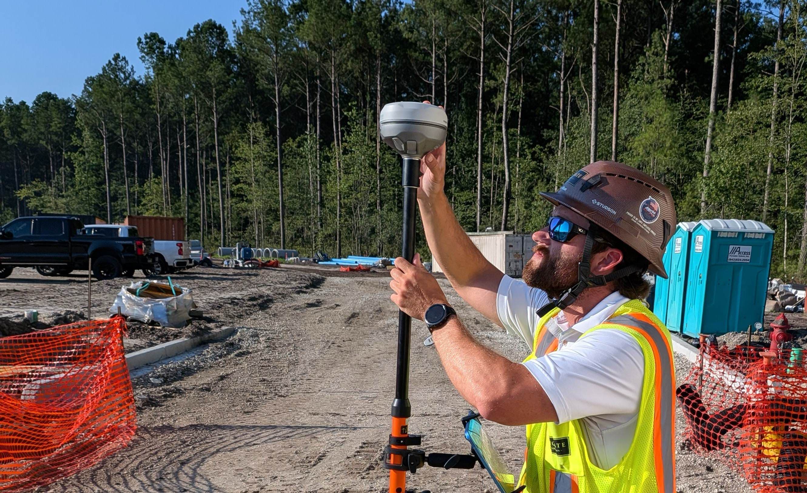 Crew member marking a point with a survey-grade GPS receiver and SiteMarker