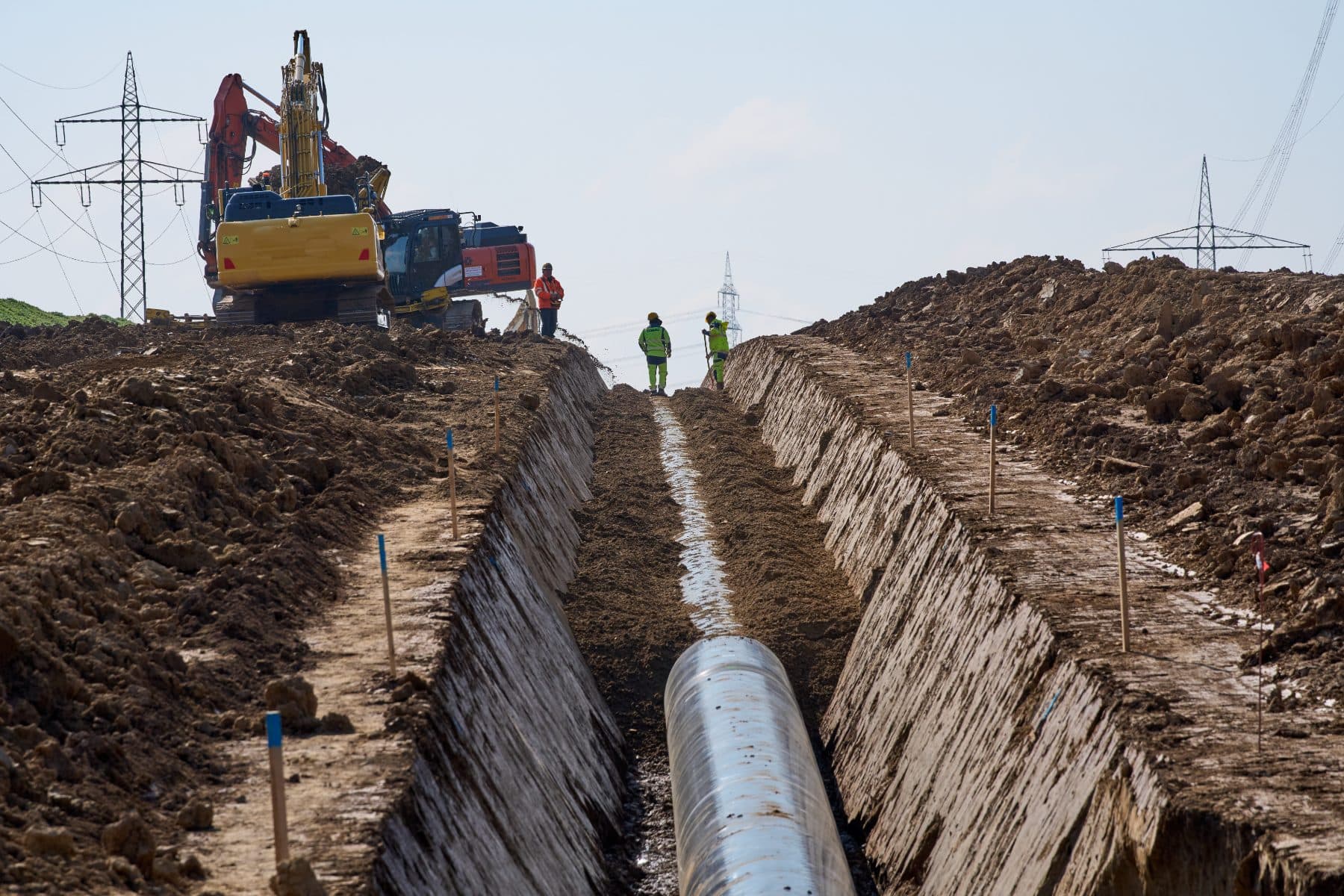 Crew documenting a pipeline trench